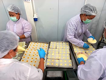 Chocolate molds being filled with gelato