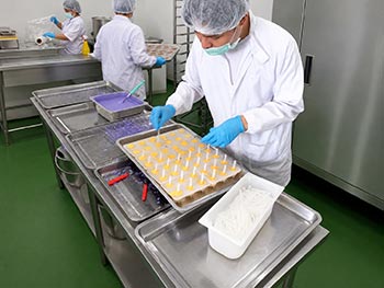 Inserting popsicle sticks into Gelato Pops