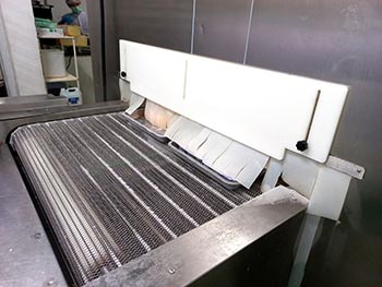 Products exiting the IQF freezer